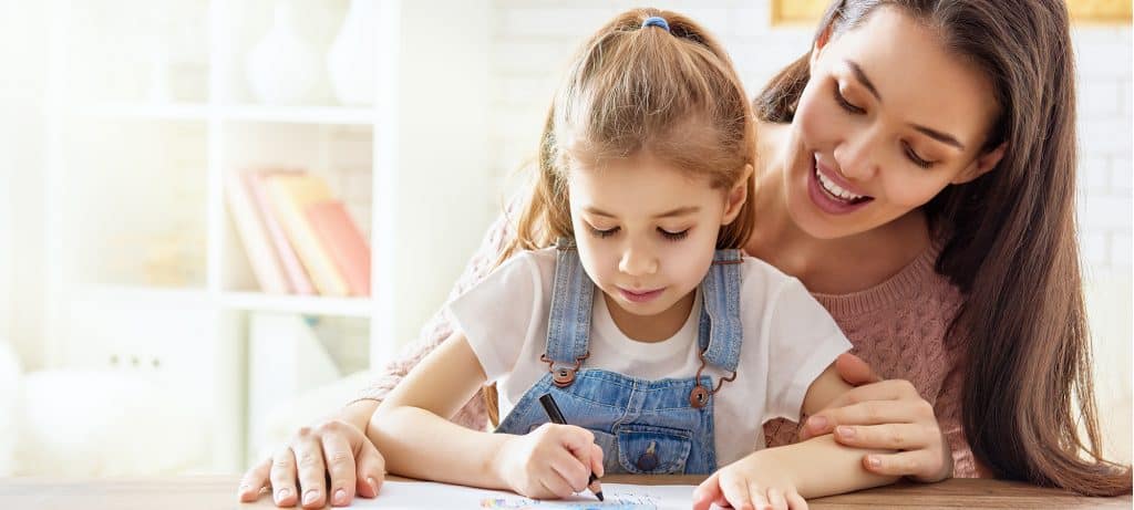 Working parent spends time with her child who is drawing